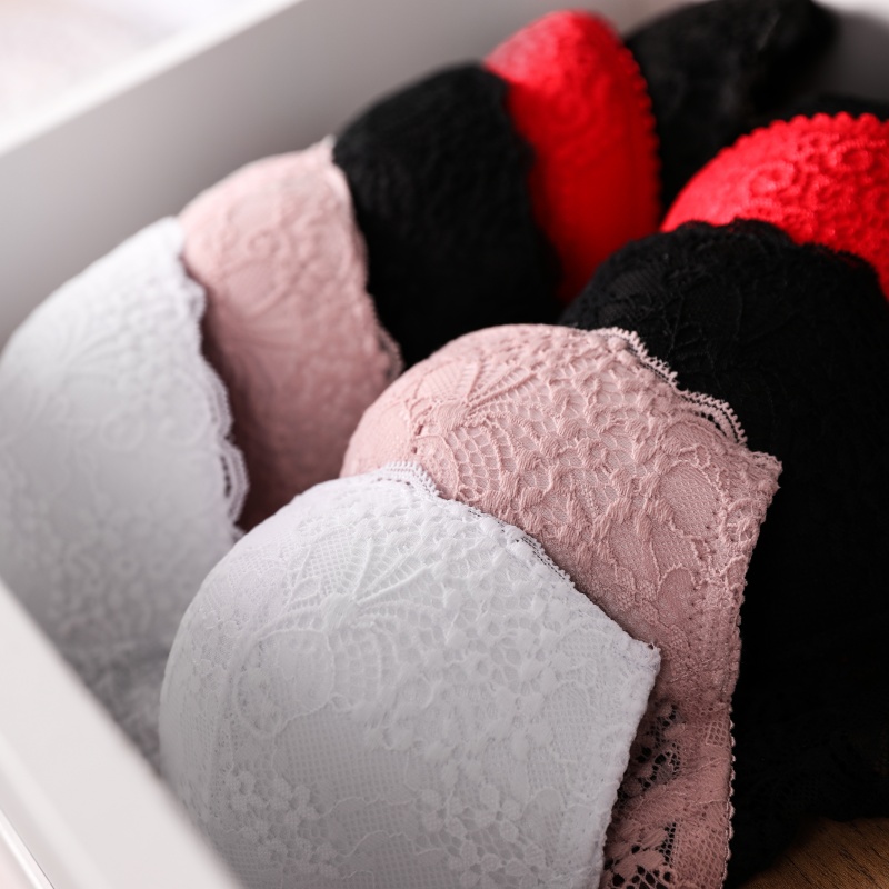 Drawer with beautiful lace bras, closeup. Stylish underwear