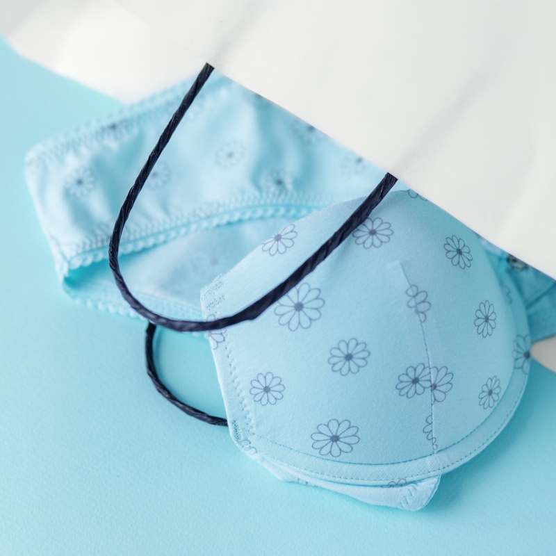 Delicate set of lingerie in a gift bag. Flat lay. The concept of clothing, accessories, shopping.